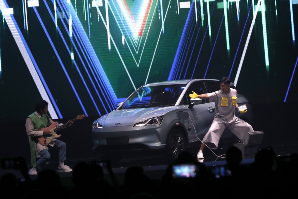 Performers present Hozon NETA V, a Chinese electric car, in Bangkok on August 24, 2022. Hozon Auto is among several Chinese EV makers with plans to set up production in Thailand. Photo: EPA-EFE