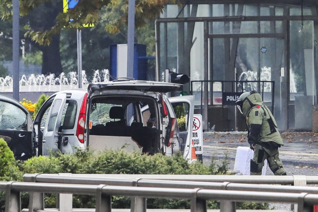 A bomb disposal expert works next to a car after an explosion in Ankara. Photo: Yavuz Ozden/Dia Images via AP