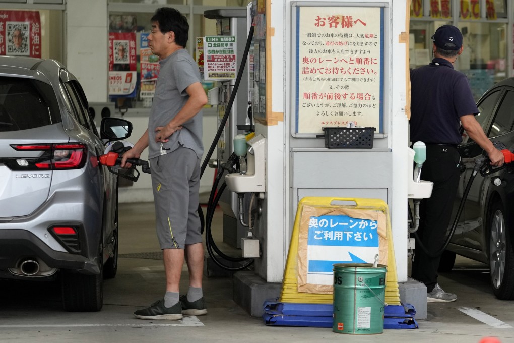 Drivers fuel their cars at a petrol station in Tokyo on September 22. Japan has, for decades, suffered timid investment trends, sluggish income growth and a dearth of risk-taking. Photo: EPA-EFE