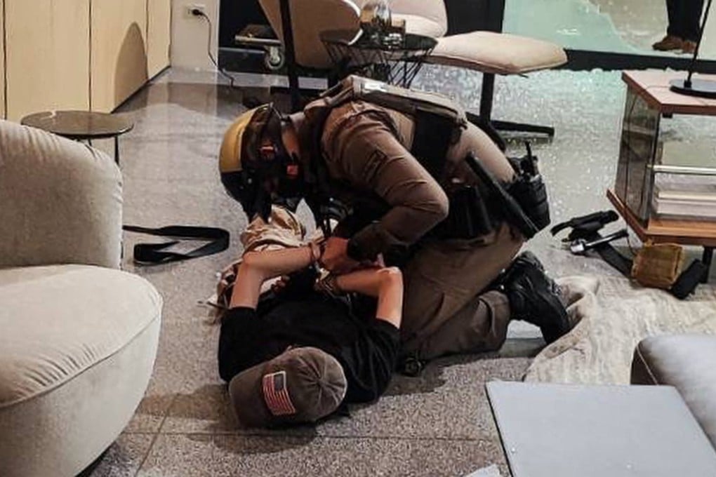 A suspect is detained following shots fired at the luxury Siam Paragon shopping centre. Photo: Reuters