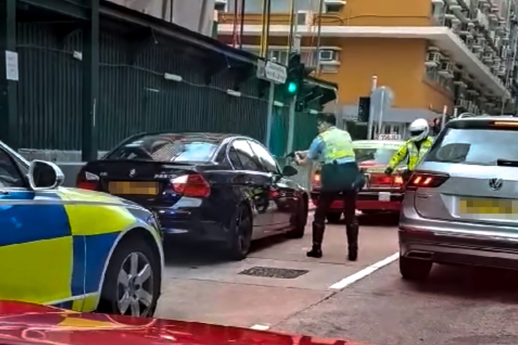 An online video shows a police officer pointing his gun at the car while trying to open its door. Photo: Handout