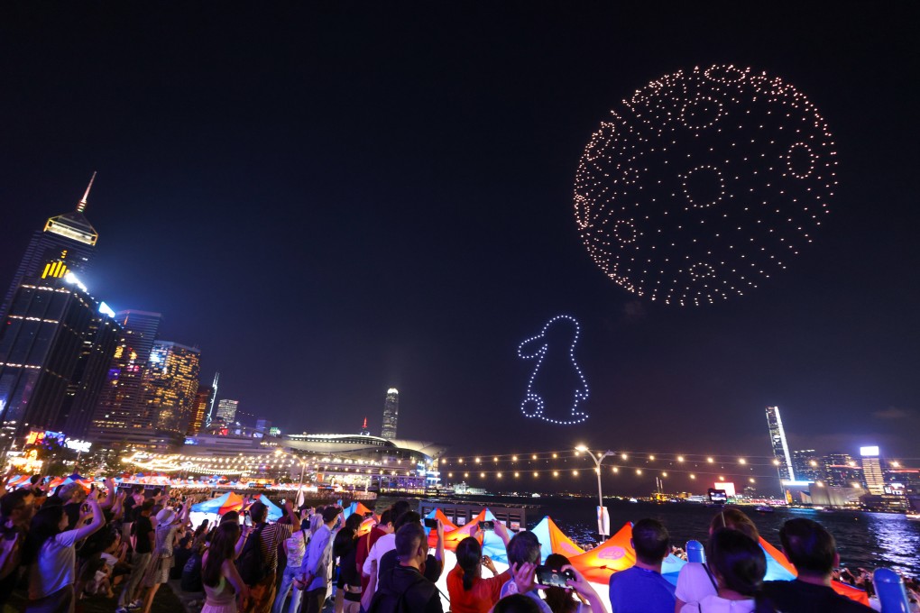 Revellers watch a light display created using drones as a part of the Waterfront Carnival at Wan Chai waterfront in Wan Chai. September 29, 2023. Photo: Yik Yeung-man