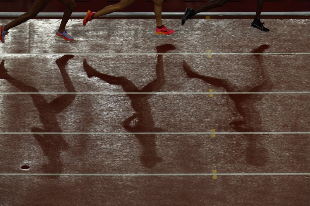 The shadows of the athletes are seen during the women’s 10,000m final at the 2023 Asian Games. Photo: Reuters