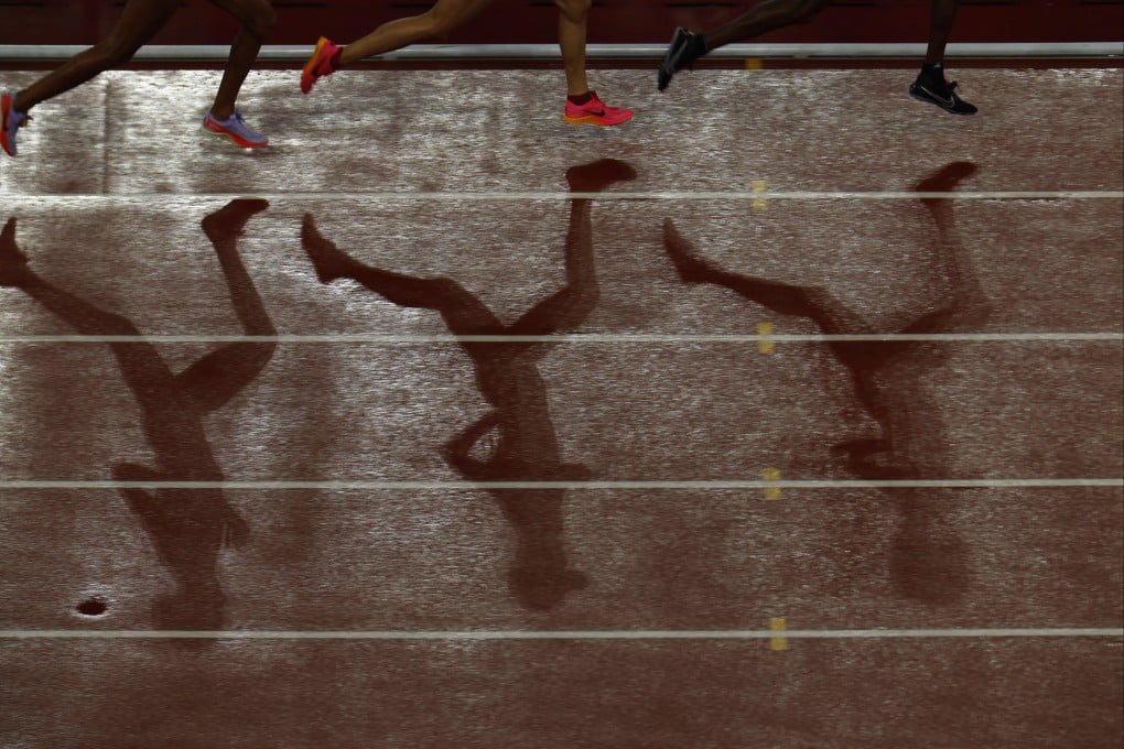 The shadows of the athletes are seen during the women’s 10,000m final at the 2023 Asian Games. Photo: Reuters