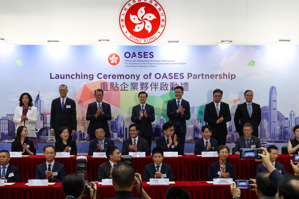 Hong Kong leader John Lee (back row, centre) with other top officials at the signing ceremony at government headquarters on Wednesday. Photo: May Tse
