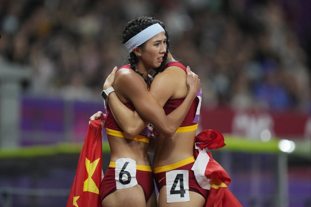 Gold medalist Lin Yuwei (left) hugs compatriot Wu Yanni after the women’s 100 metres hurdles final at the 19th Asian Games in Hangzhou. Photo: AP