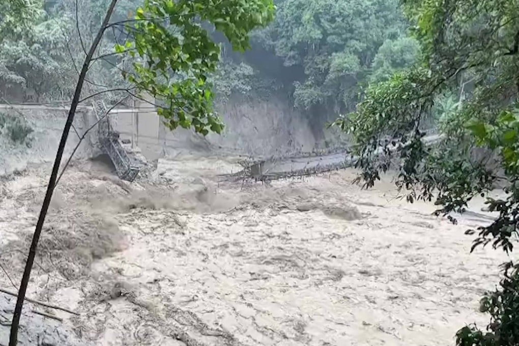 This screengrab from video released by the Indian Army shows a damaged steel bridge over the flooded Teesta River in north Sikkim’s Chungthang region on Wednesday. Photo: Handout/AFP