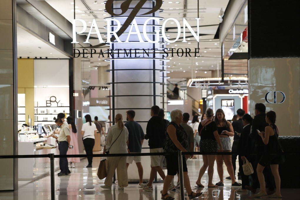 People shop a day after a shooting attack inside the Siam Paragon mall in Bangkok on Wednesday. Photo: EPA-EFE