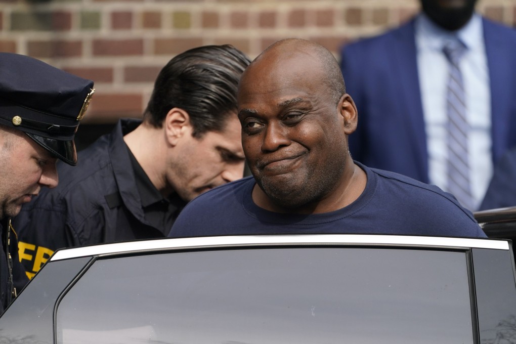 Law enforcement officials lead subway shooter Frank James away from a police station and into a vehicle in New York in April 2022. Photo: AP
