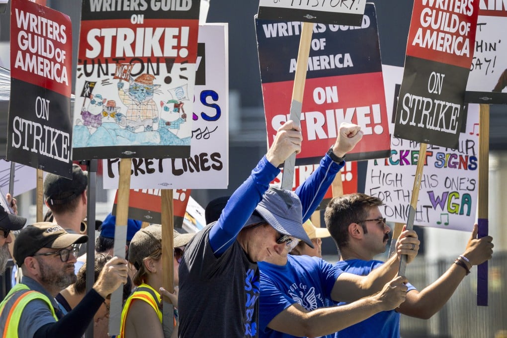 Members of the Writers Guild of America picket in front of CBS Television City in Los Angeles on September 24. With a growing number of jobs threatened by AI automation, entrepreneurial education and workers possessing a variety of skills are more important than ever. Photo: TNS