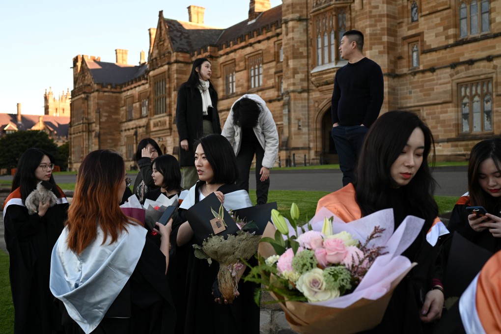 Shiyu Bao, centre, and her fellow classmates who are international students from China, get ready to take pictures in their graduation gowns around campus at the University of Sydney on July 4, 2020. Families are rethinking sending their students to study abroad amid changed economic circumstances. Photo: Reuters