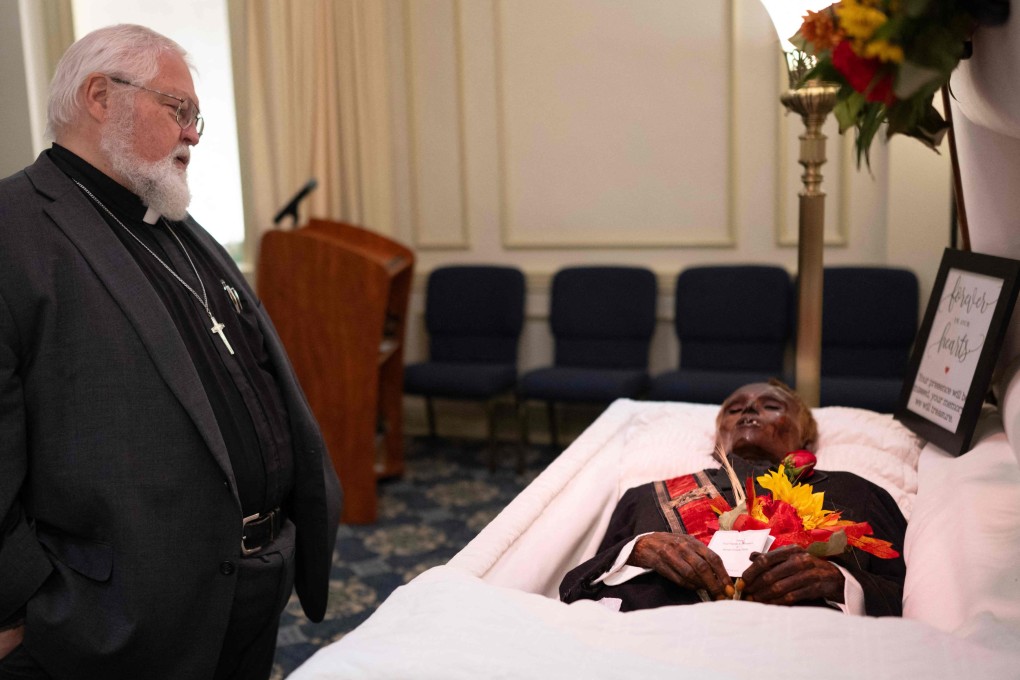 Revered Robert Whitmer visits the body of James Murphy, nicknamed “Stoneman Willie”, during his funeral service in Reading, Pennsylvania, on Saturday. Photo: AFP