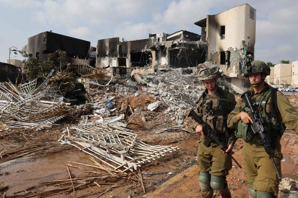 Soldiers walk in front of an Israeli police station that was damaged during battles to dislodge Hamas militants on Sunday. Photo: AFP