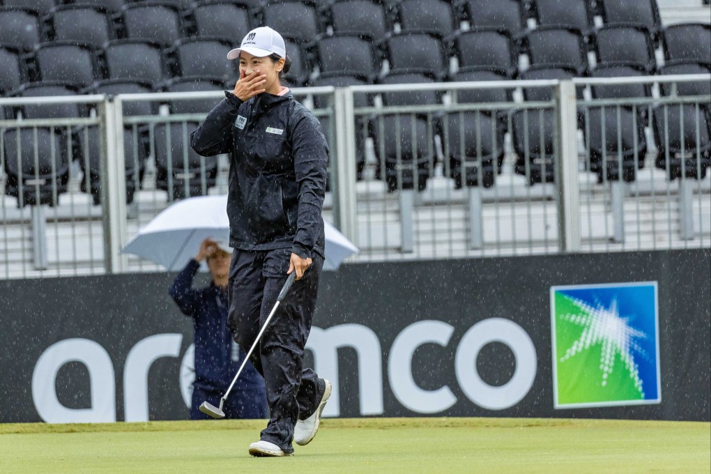 Janet Lin smiles through the rain as she sinks her winning birdie putt. Photo: Aramco Team Series