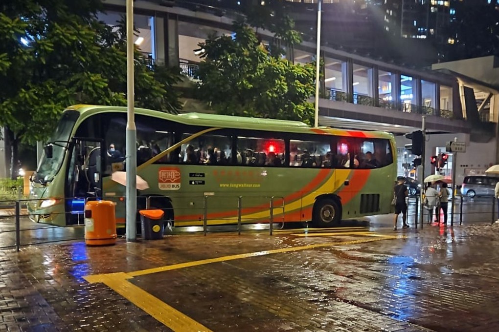 Private coaches manned by volunteer drivers pick up passengers stranded by Typhoon Koinu at Tsuen Wan West MTR station. Photo: JoJo Bus