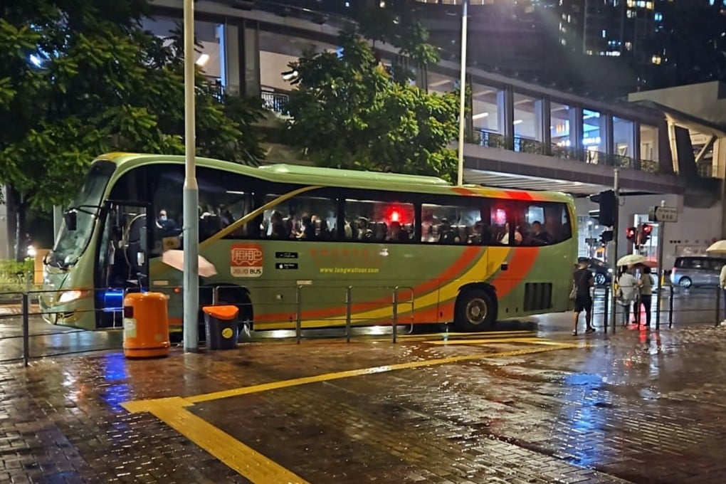 Private coaches manned by volunteer drivers pick up passengers stranded by Typhoon Koinu at Tsuen Wan West MTR station. Photo: JoJo Bus