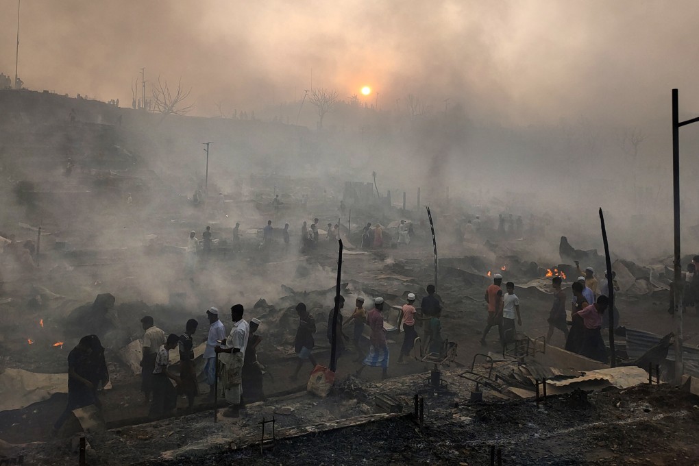 Rohingya refugees try to salvage their belongings after a major fire in a camp in Cox’s Bazar in March. Photo: AP