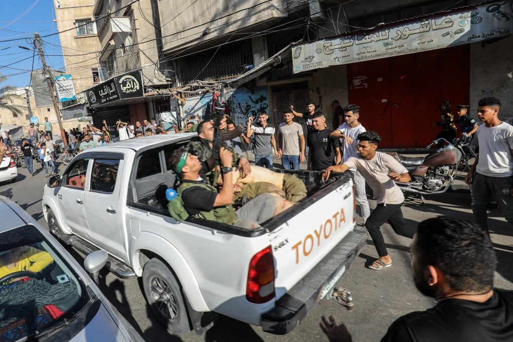 Palestinian militants surround a truck reportedly carrying a captured Israeli after crossing the border fence with Israel from Khan Yunis. Photo: dpa