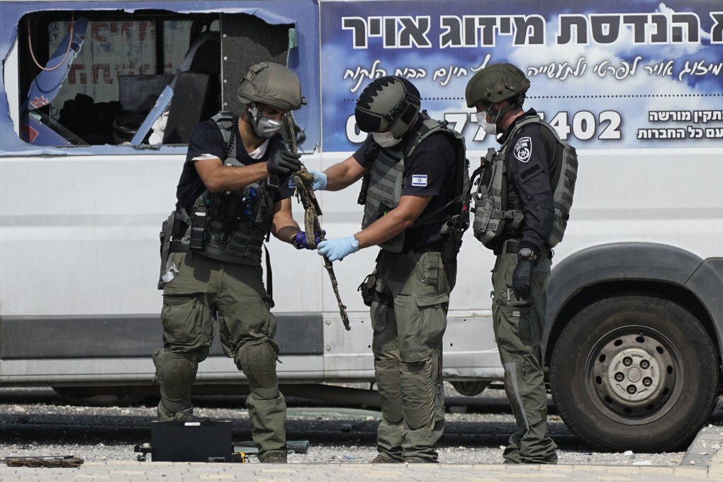 Israeli police retrieve weapons outside a police station in Sderot, Israel on Sunday. On Monday, the US said it is sending fresh supplies of air defences, munitions and other security aid to Israel. Photo: AP