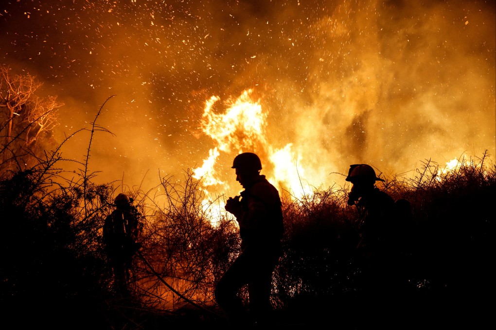 Firefighters work to put out a blaze in an open field following a raid by Hamas gunmen from across the Gaza border, near a hospital in southern Israel on Saturday. Photo: Reuters
