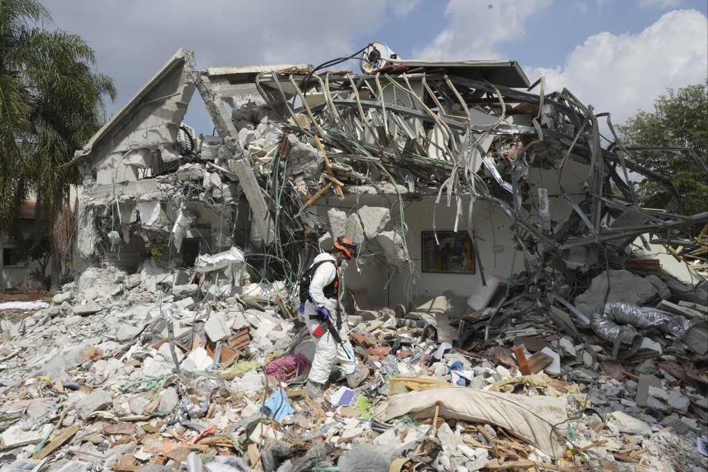 An Israeli soldier walks by a house destroyed by Hamas militants in Kibbutz Be’eri on October 11. Photo: AP