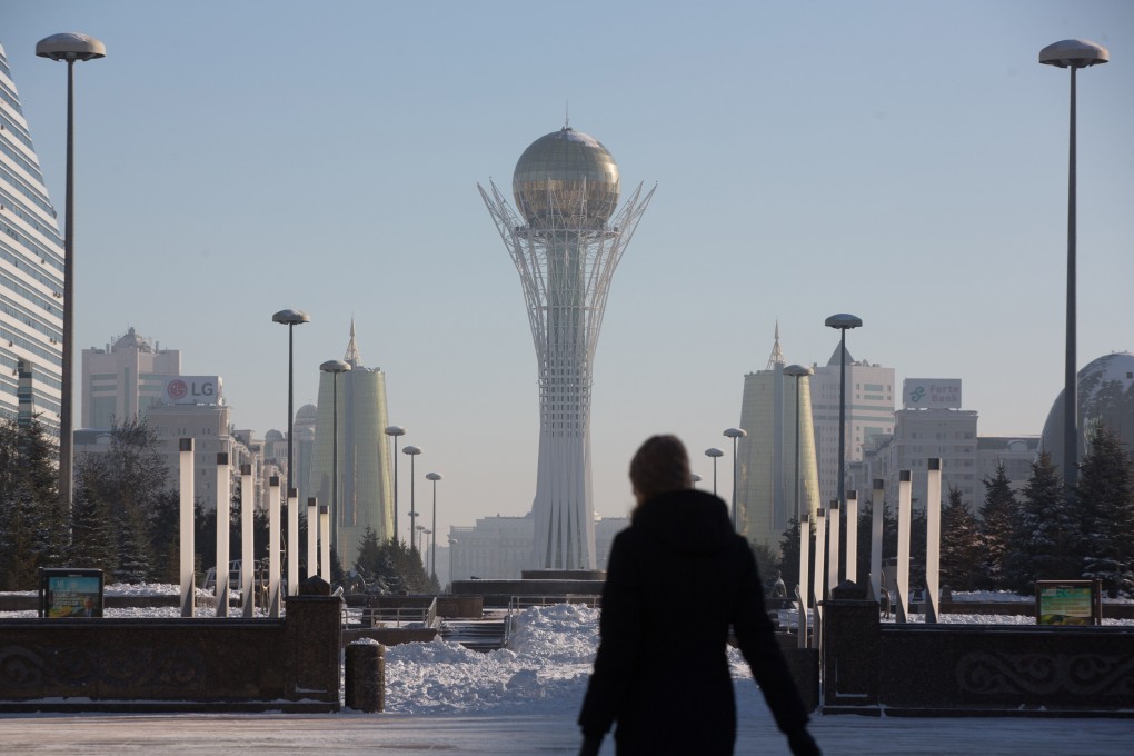 The Bayterek tower monument is flanked by the golden twin towers of Ministries House in Astana. Kazakhstan’s economic growth, propelled by oil and gas, has slowed in part from fluctuations in global commodity prices. Photo: Bloomberg