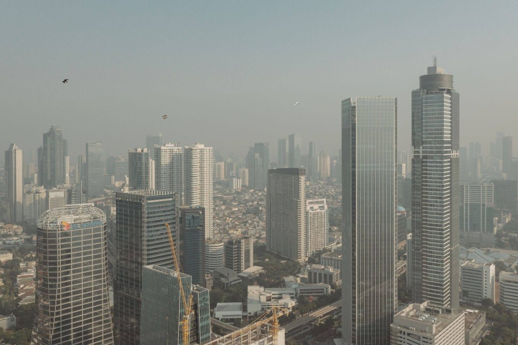 Buildings shrouded in smog in Jakarta. Southeast Asia, according to one estimate by the Asian Development Bank, requires US$210 billion annually through 2030 for climate infrastructure investment. Photo: Bloomberg