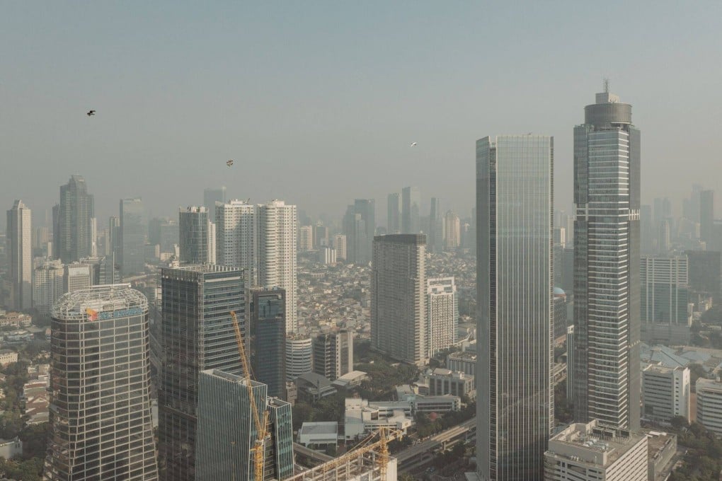 Buildings shrouded in smog in Jakarta. Southeast Asia, according to one estimate by the Asian Development Bank, requires US$210 billion annually through 2030 for climate infrastructure investment. Photo: Bloomberg