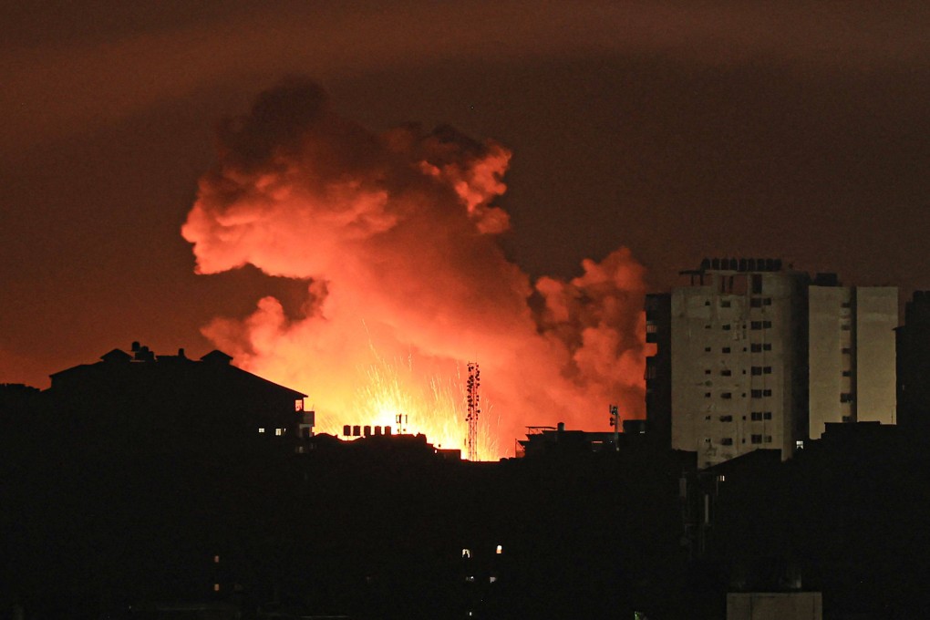 Fire and smoke rise above buildings in Gaza City during an Israeli air strike early on Friday. Photo: AFP