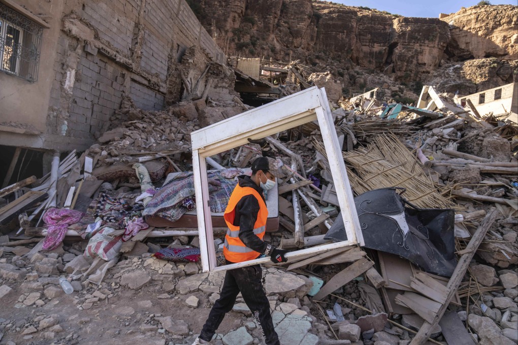 A volunteer salvages furniture from homes damaged by an earthquake in Imi N’tala town outside Marrakech, Morocco, on September 13. Photo: AP