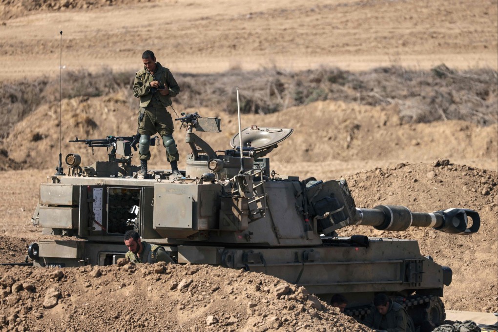 An Israeli soldier stands on armoured vehicle stationed close to the border with the Gaza Strip on October 15. Photo: AFP