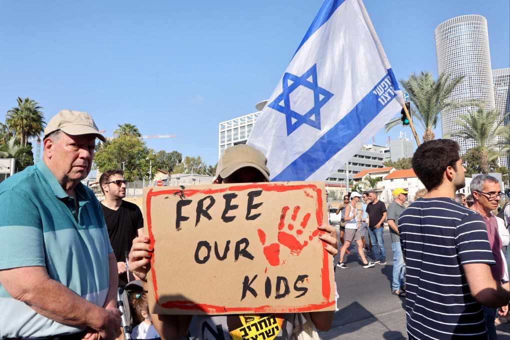 Supporters and family members of Israeli hostages snatched by Hamas protest outside the Kirya military base in Tel Aviv on Saturday. Photo: AFP
