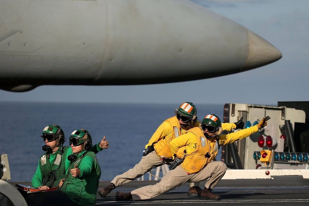 A flight deck crew prepares to launch an F-18 jet from the deck of the USS Dwight D Eisenhower. File photo: AFP