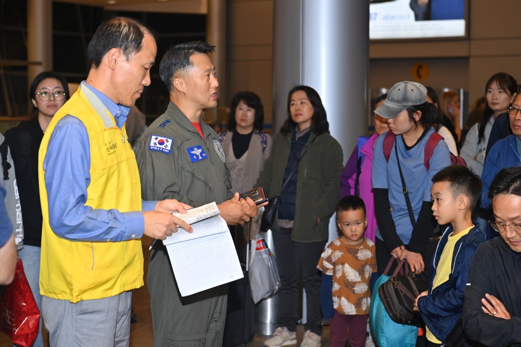 People being briefed by military and civilian personnel ahead of boarding a military aircraft to leave for South Korea at an airport in Tel Aviv, Israel, on Friday. Photo: EPA-EFE/South Korean Defence Ministry