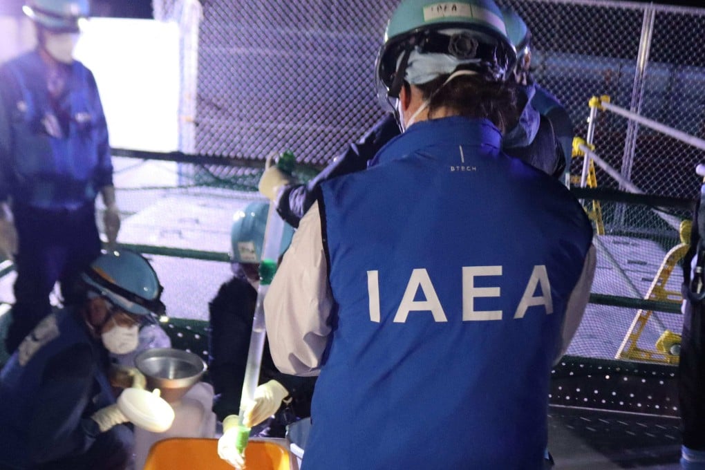 A photo released by TEPCO on August 23 shows International Atomic Energy Agency staff witnessing sampling for the initial release of treated water at the Fukushima Daiichi nuclear power plant in Okuma, Fukushima prefecture. Photo: Handout