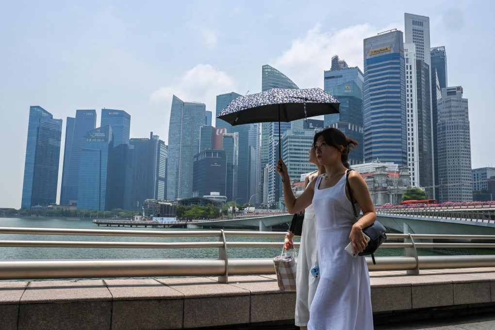 People walk along the walkway at Marina Bay in Singapore. Photo: AFP