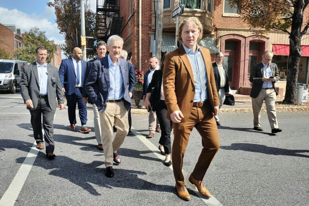 US Federal Reserve chairman Jerome Powell (centre) and Kevin Schreiber (foreground), president of the York County Economic Alliance, walk down the street during a visit to York, Pennsylvania, on October 2, to meet local economic players. Photo: AFP