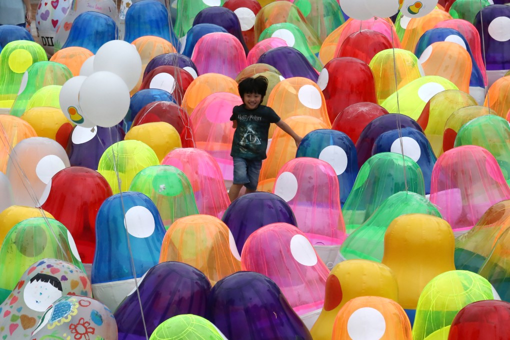 A child plays among Roly-poly toys at Kowloon Park in Tsim Sha Tsui on April 27, 2019, as part of a display meant to raise public awareness of students’ mental health. Photo: Jonathan Wong