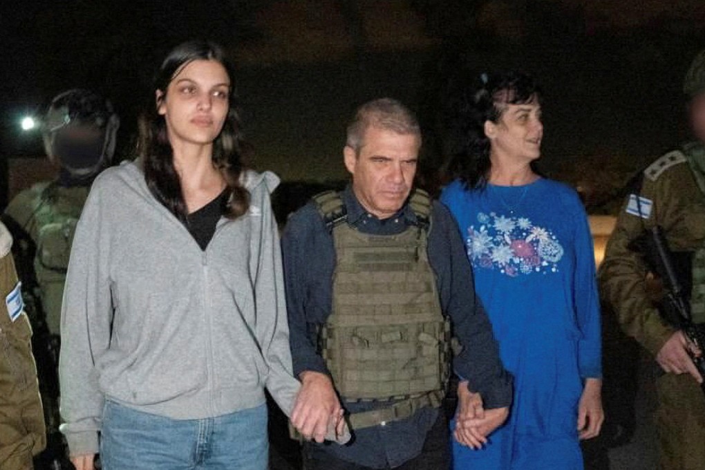 Judith Raanan and her daughter Natalie, US citizens who were taken as hostages by Hamas militants, walk while holding hands with Brigadier-General (Retired) Gal Hirsch, Israel’s coordinator for the captives and missing, after they were released. Photo: Government of Israel via Reuters