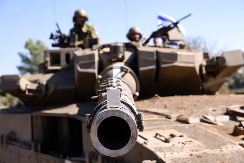 Israeli soldiers on a Merkava tank at an undisclosed location on the border with Lebanon. Photo: AFP