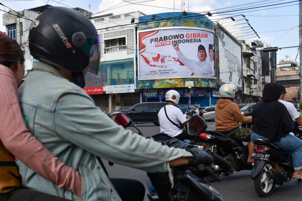 Motorists drive past a banner depicting defence minister Prabowo Subianto with Gibran Rakabuming Raka, the eldest son of Indonesian President Joko Widodo, in Medan, North Sumatra province, Indonesia on October 15. Photo: Antara Foto via Reuters