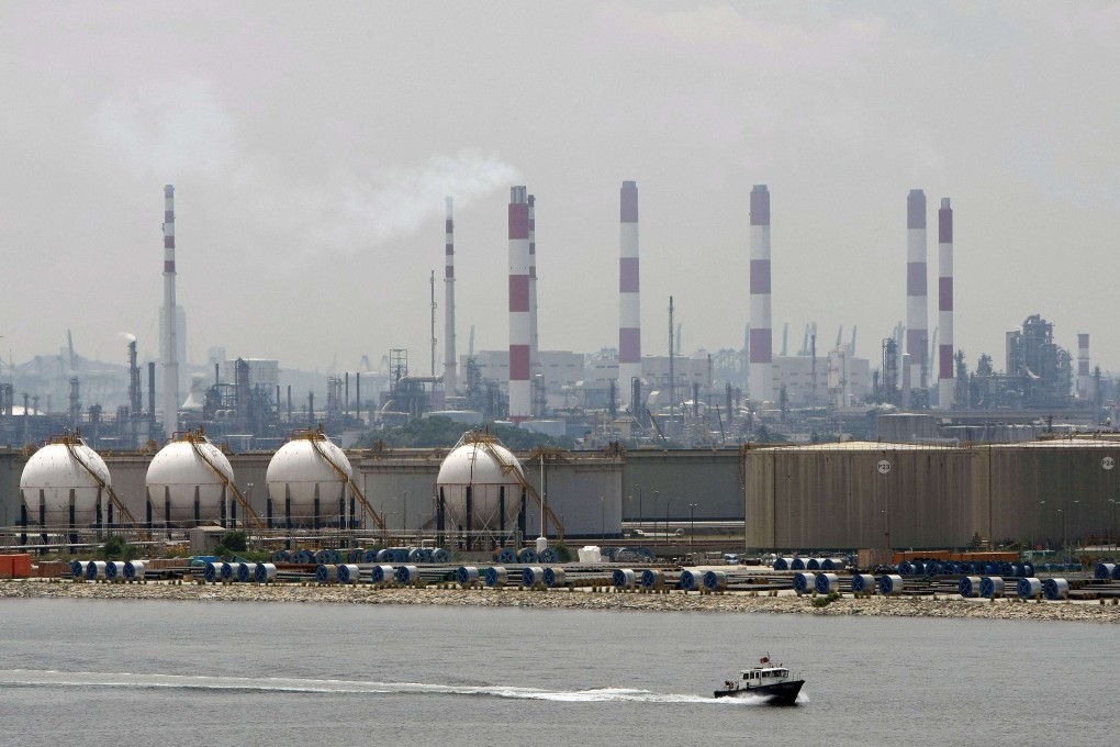 A boat passes in front of an oil refinery located on Jurong Island. Singapore also plans to develop a low- or zero-carbon ammonia project on the island to generate power and for ship bunkering, the government said. Photo: Reuters