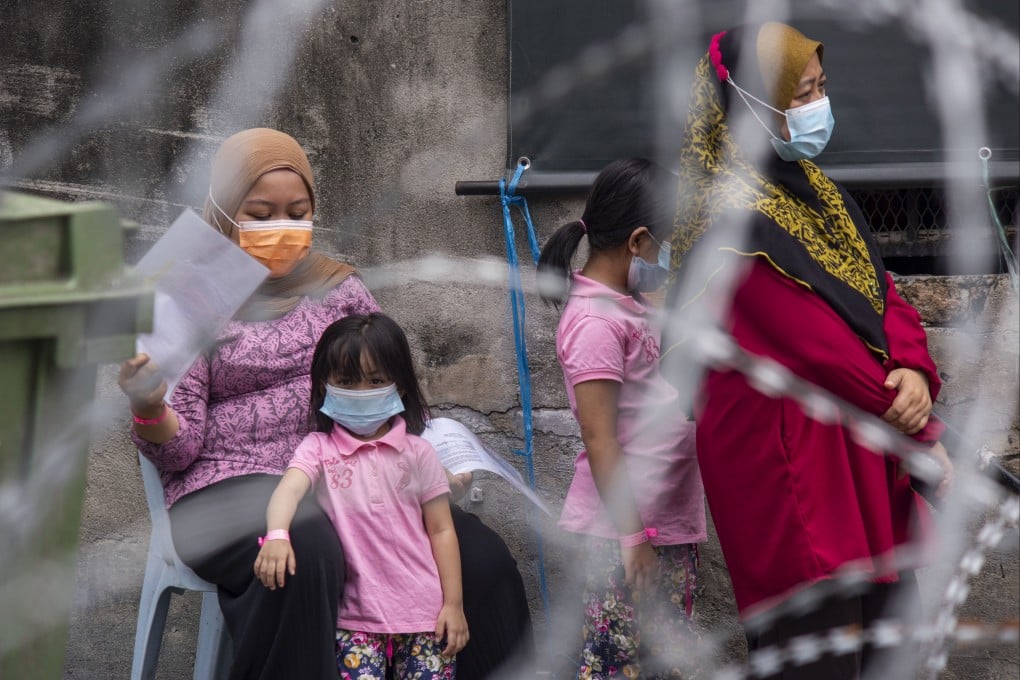 Children wait with their carers for nasal swab tests in an area of Kuala Lumpur under Covid lockdown in July 2021. The pandemic had exposed constraints on Malaysia’s mental-health professionals, the country’s health minister said. Photo: Xinhua