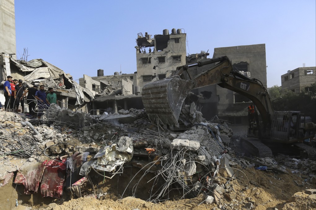 Palestinians inspect the damage to destroyed houses after Israeli air strikes on Gaza City on Tuesday. Photo: AP