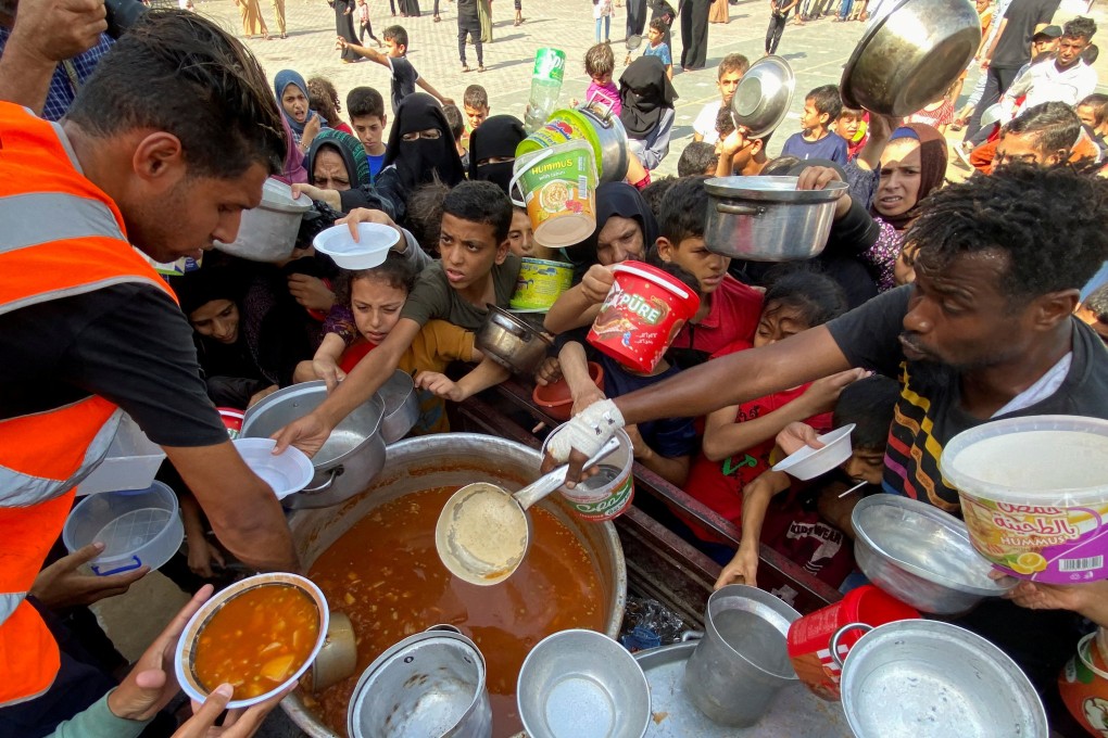 Palestinians get food at a UN-run school in Rafah, Gaza, where they have taken refuge. Photo: Reuters