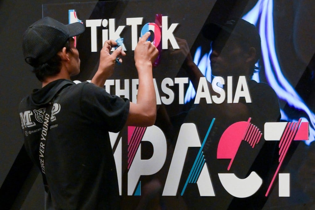 A worker finishing signage before the TikTok Southeast Asia Impact Forum 2023 in Jakarta. An Indonesian TikTokker accused of blasphemy against Christianity has been arrested in North Sumatra province after videos of him mocking the religion went viral on the popular Chinese-owned app. Photo: AFP