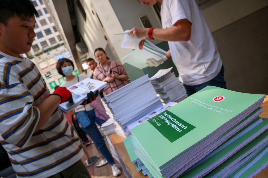 Officials handout copies of this year’s policy address in Wan Chai. Photo: Dickson Lee