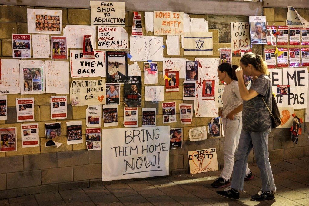 A wall of posters in Tel Aviv identifying the Israeli hostages held by Palestinian militants. Photo: AFP