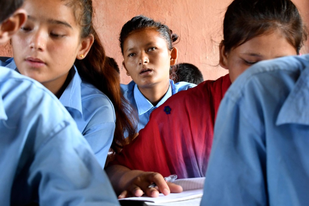 A child marriage survivor attends school in Barahatal in Surkhet district in Nepal in 2019. Child marriage can have an intergenerational impact; girls who marry young tend to attain lower levels of education, and so might their children. Photo: AFP
