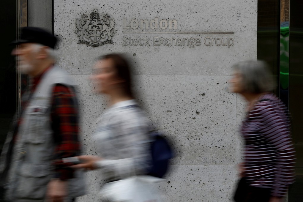 People walk past the entrance of the London Stock Exchange in London. Photo: Reuters